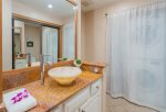 Guest bathroom features shower, toilet and washer and dryer with a starter supply of detergent